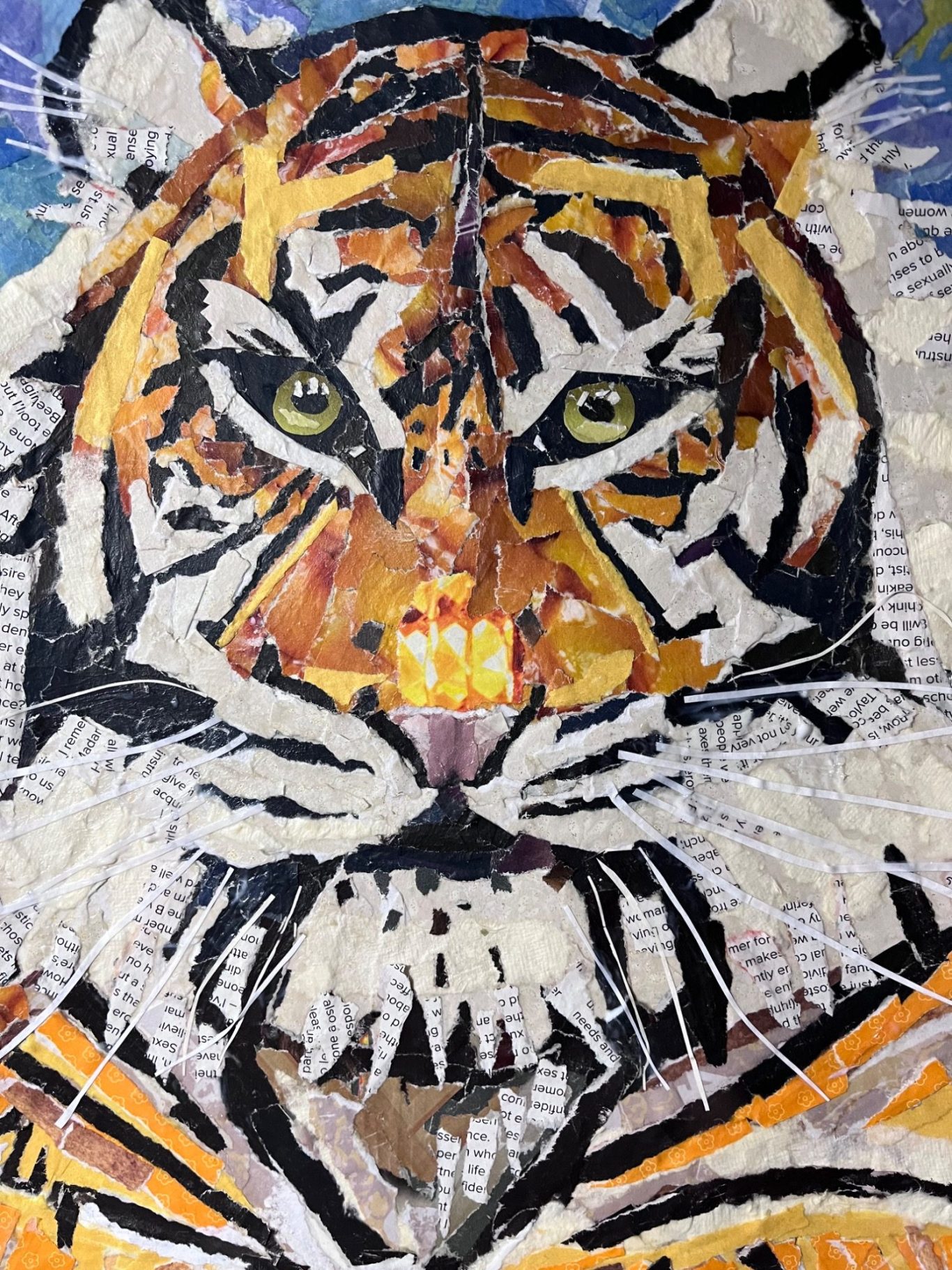 Tiger collage Mosaic artwork of a tiger's face with vivid colours and intricate details.